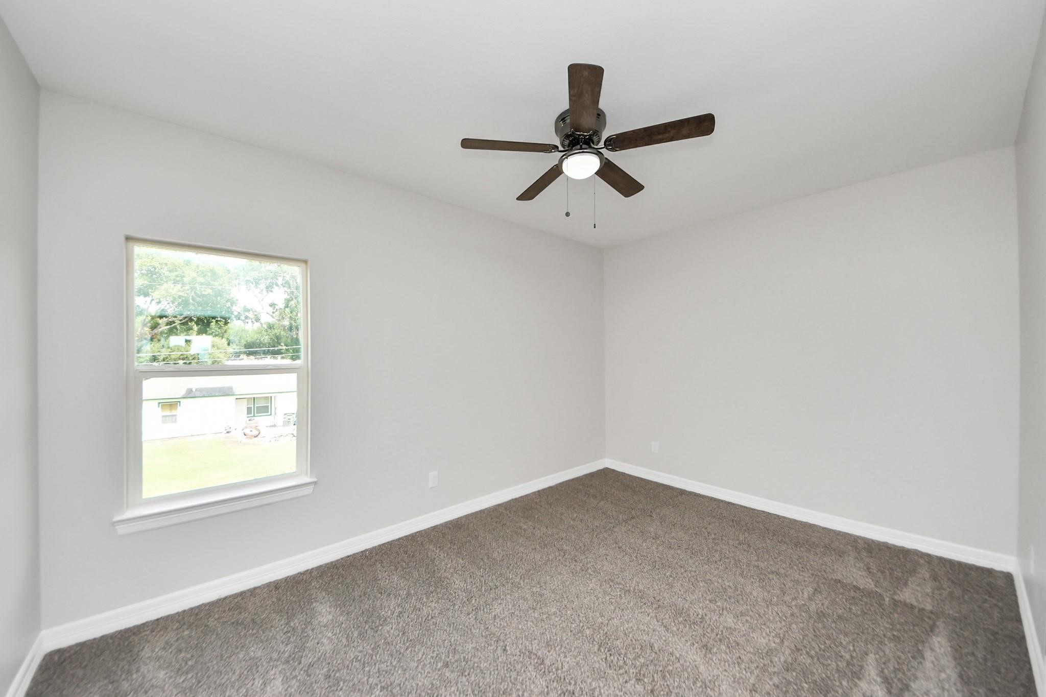 418 North 4th Street Beasley, TX 77417 - Photo 21 of 29 a view of a big room with a ceiling fan and window