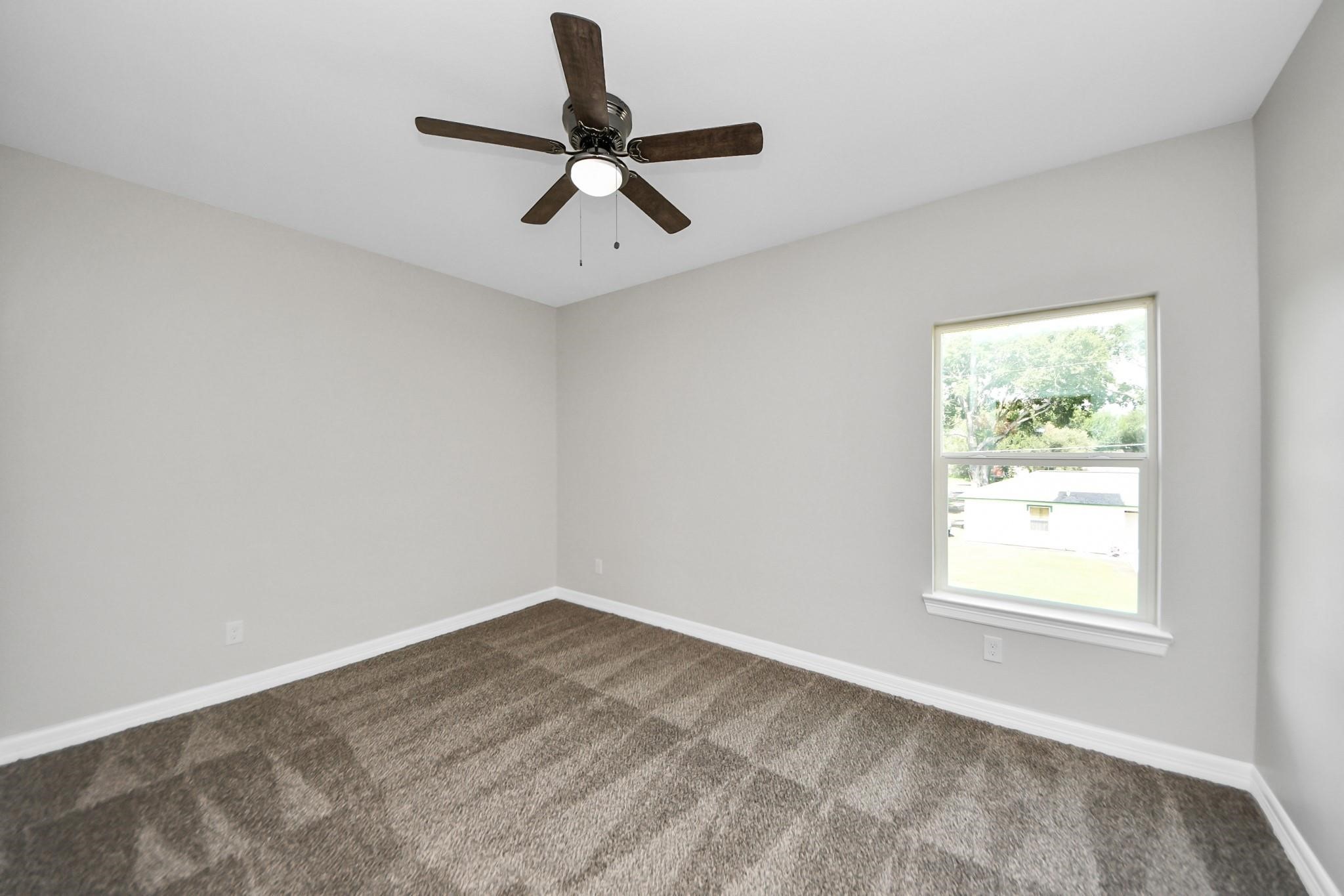 418 North 4th Street Beasley, TX 77417 - Photo 23 of 29 an empty room with a window and a fan