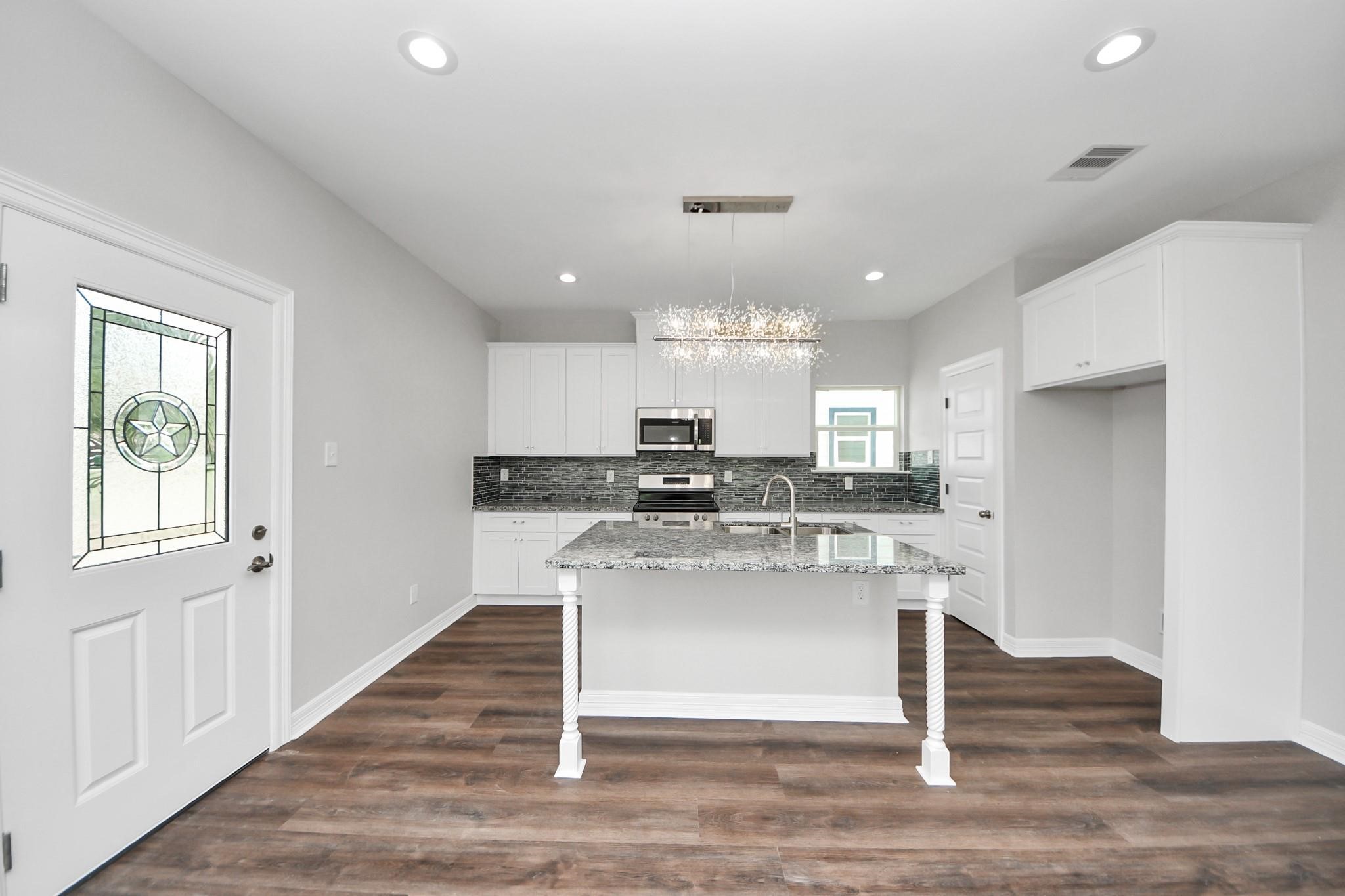 418 North 4th Street Beasley, TX 77417 - Photo 8 of 29 a kitchen with kitchen island sink stove and refrigerator