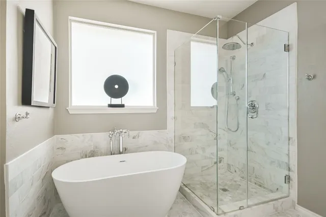 a white bath tub sitting next to a shower