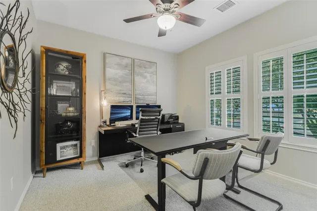 a workspace with wooden floor and windows