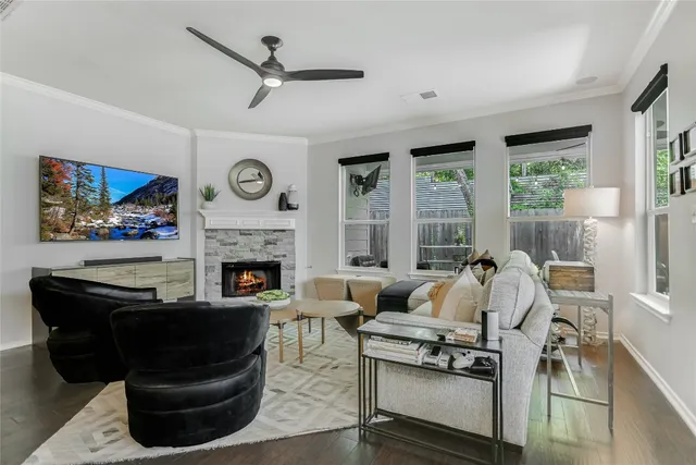 a living room with furniture a large window and a fireplace