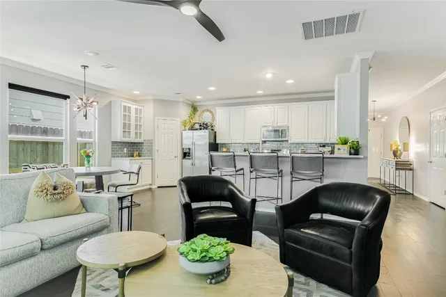 a kitchen with a refrigerator and a dining table