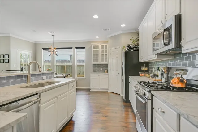 a kitchen with a sink stove and cabinets