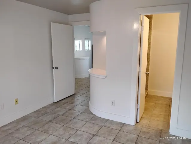 a view of kitchen with kitchen island wooden floor and refrigerator