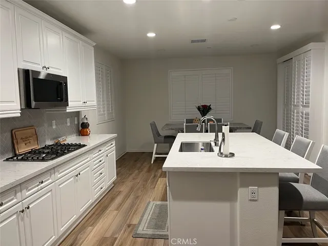 a kitchen that has a sink and a stove top oven