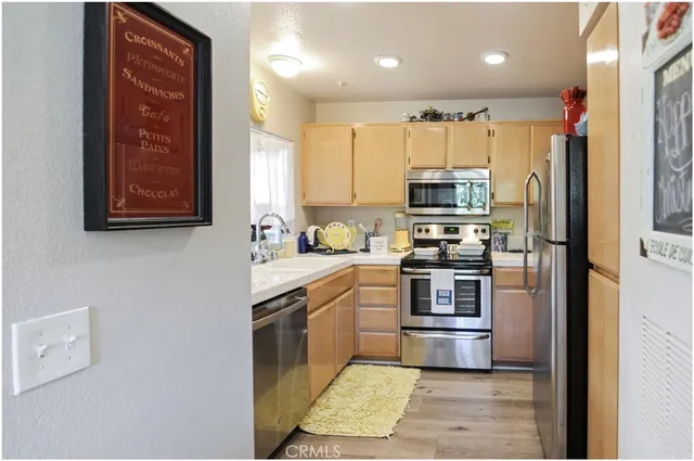 a kitchen with stainless steel appliances granite countertop a refrigerator and a stove