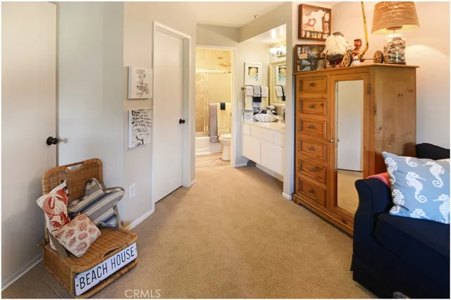 a living room with furniture a flat screen tv and a window