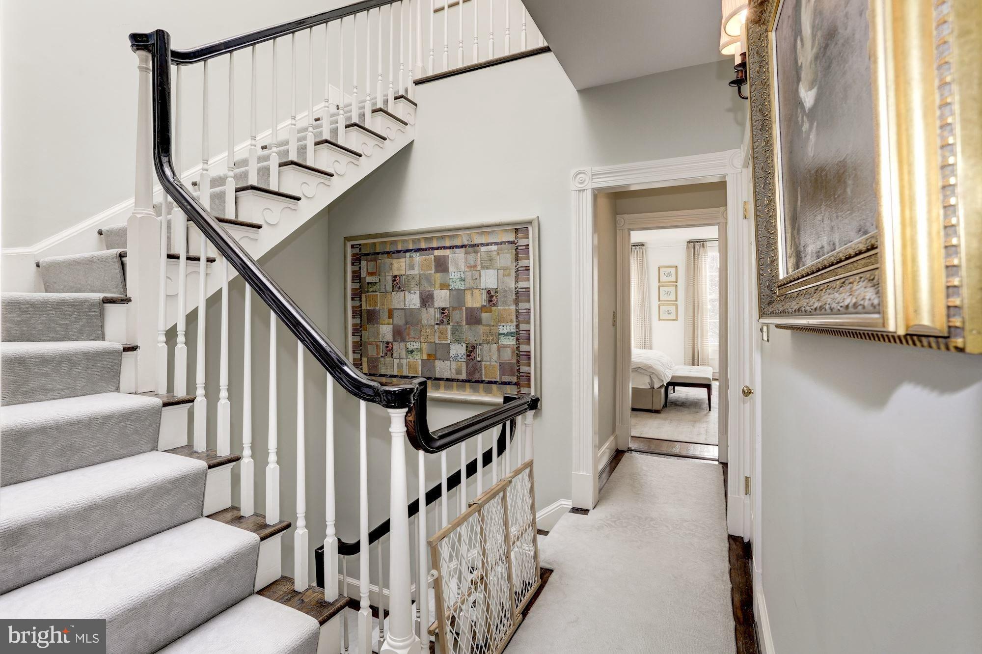 3224 Volta Place Northwest Washington, DC 20007 - Photo 19 of 35 a view of staircase with lots of frames on wall and a window