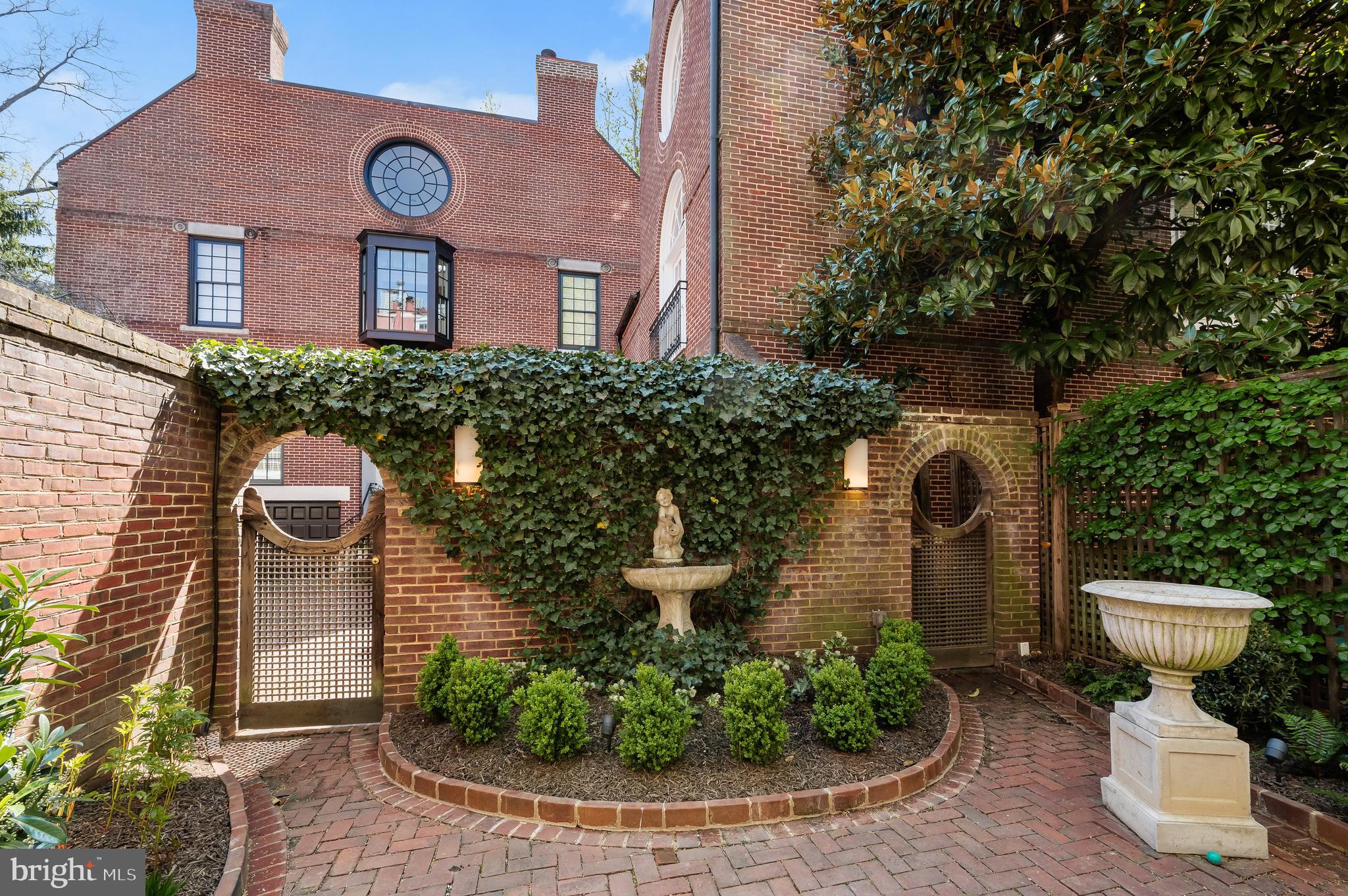 3224 Volta Place Northwest Washington, DC 20007 - Photo 33 of 35 a front view of a house with a yard and fountain