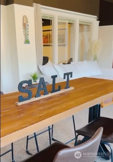 a view of a dining room with furniture and window
