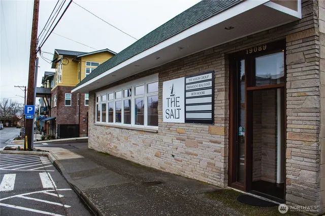 a view of a building with cars parked