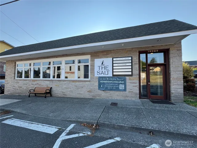 a view of building with car parked