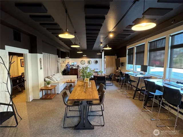 a living room with furniture a flat screen tv and a large window