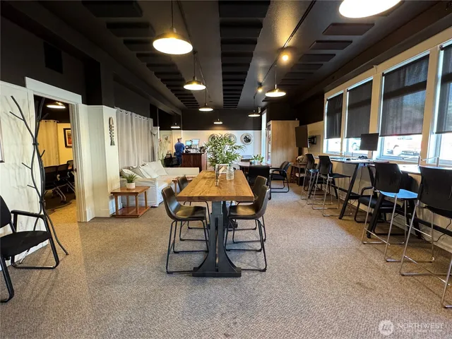 a dining room with furniture and a flat screen tv