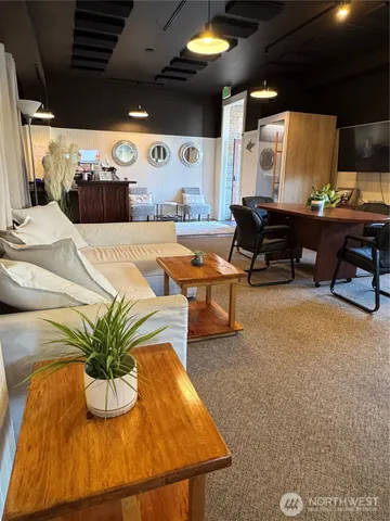 a dining room with furniture and a floor to ceiling window