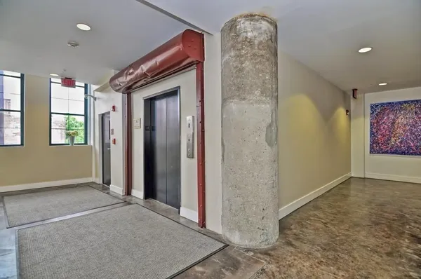 an empty room with windows and closet