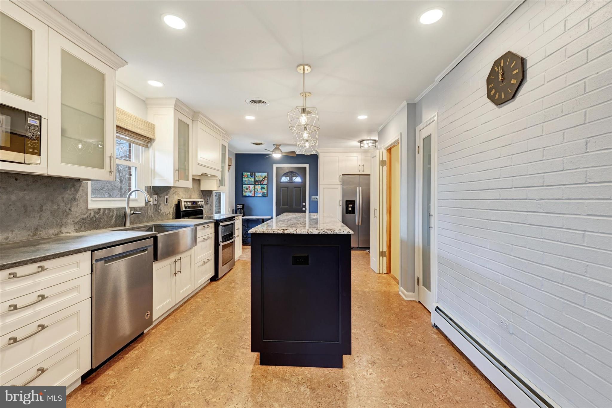 13324 Manor Road Baldwin, MD 21013 - Photo 12 of 34 a large kitchen with a counter space a sink and stainless steel appliances