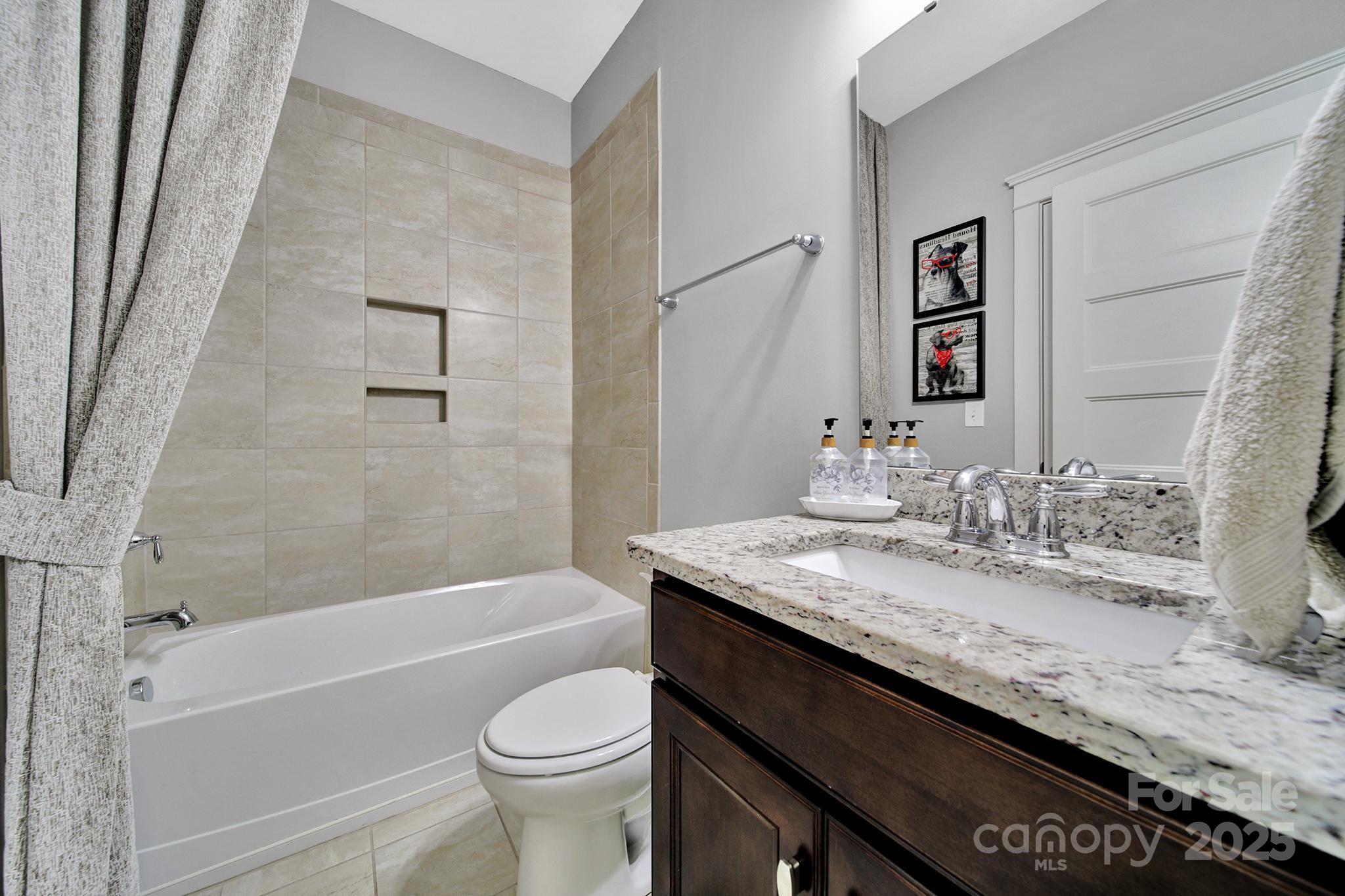 2015 Knocktree Drive Indian Trail, NC 28079 - Photo 15 of 45 a bathroom with a granite countertop sink toilet and bathtub