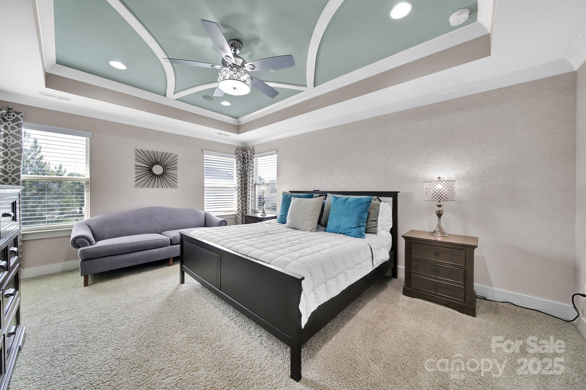 2015 Knocktree Drive Indian Trail, NC 28079 - Photo 19 of 45 a bedroom with a large bed a chandelier and a couch