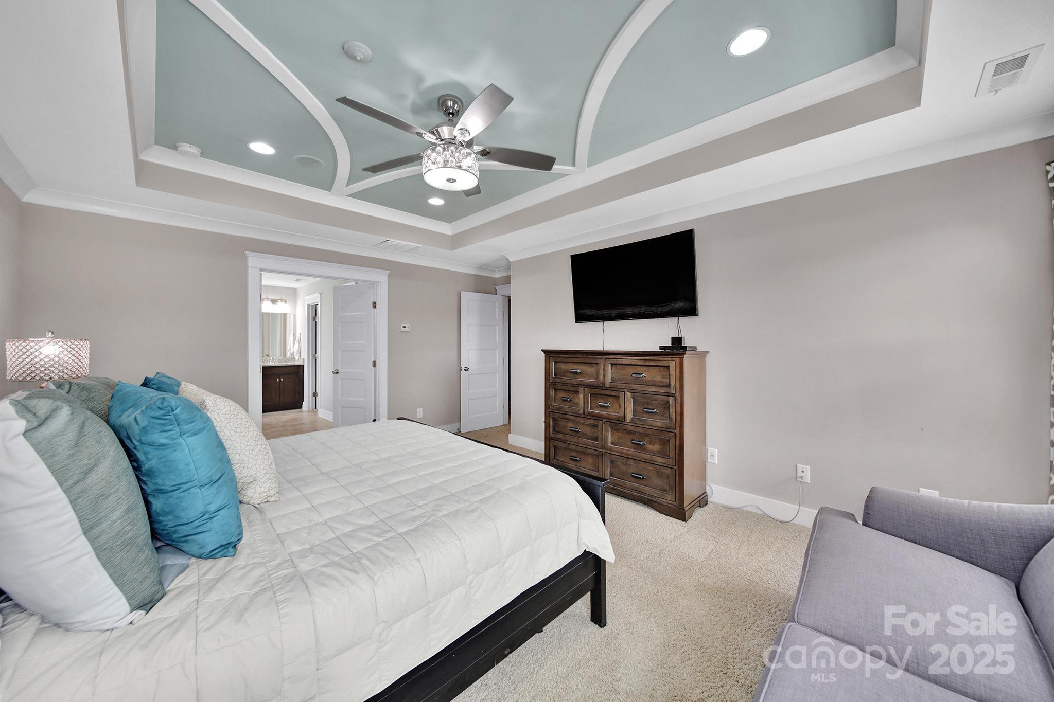 2015 Knocktree Drive Indian Trail, NC 28079 - Photo 20 of 45 a spacious bedroom with a bed and a flat screen tv