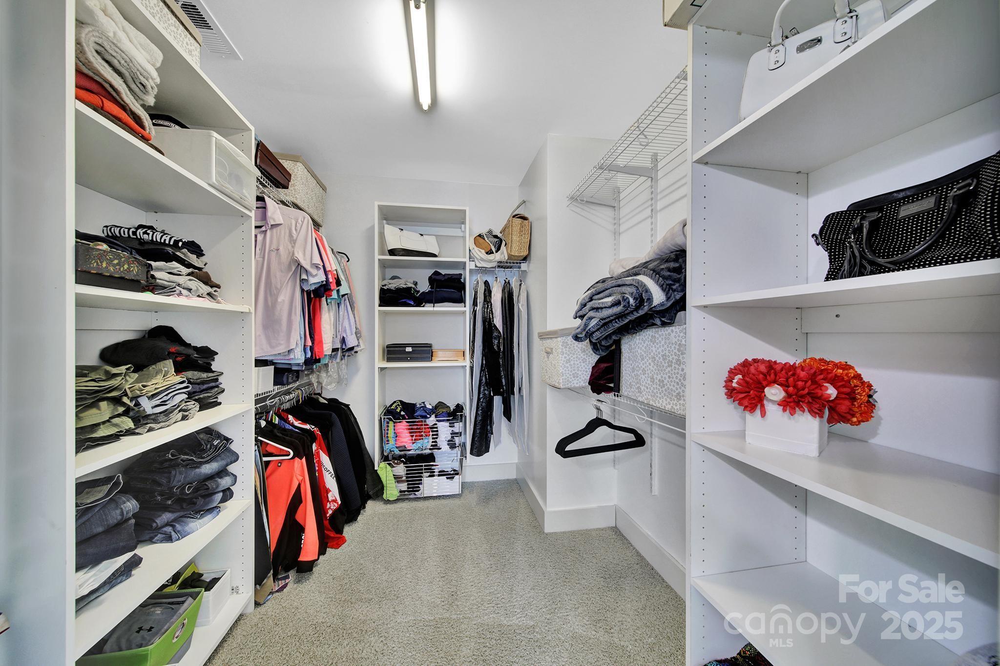 2015 Knocktree Drive Indian Trail, NC 28079 - Photo 23 of 45 a view of walk in closet with clothes and shoes