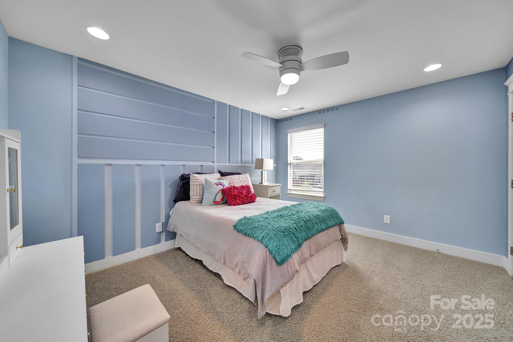 2015 Knocktree Drive Indian Trail, NC 28079 - Photo 26 of 45 a spacious bedroom with a bed and a chandelier