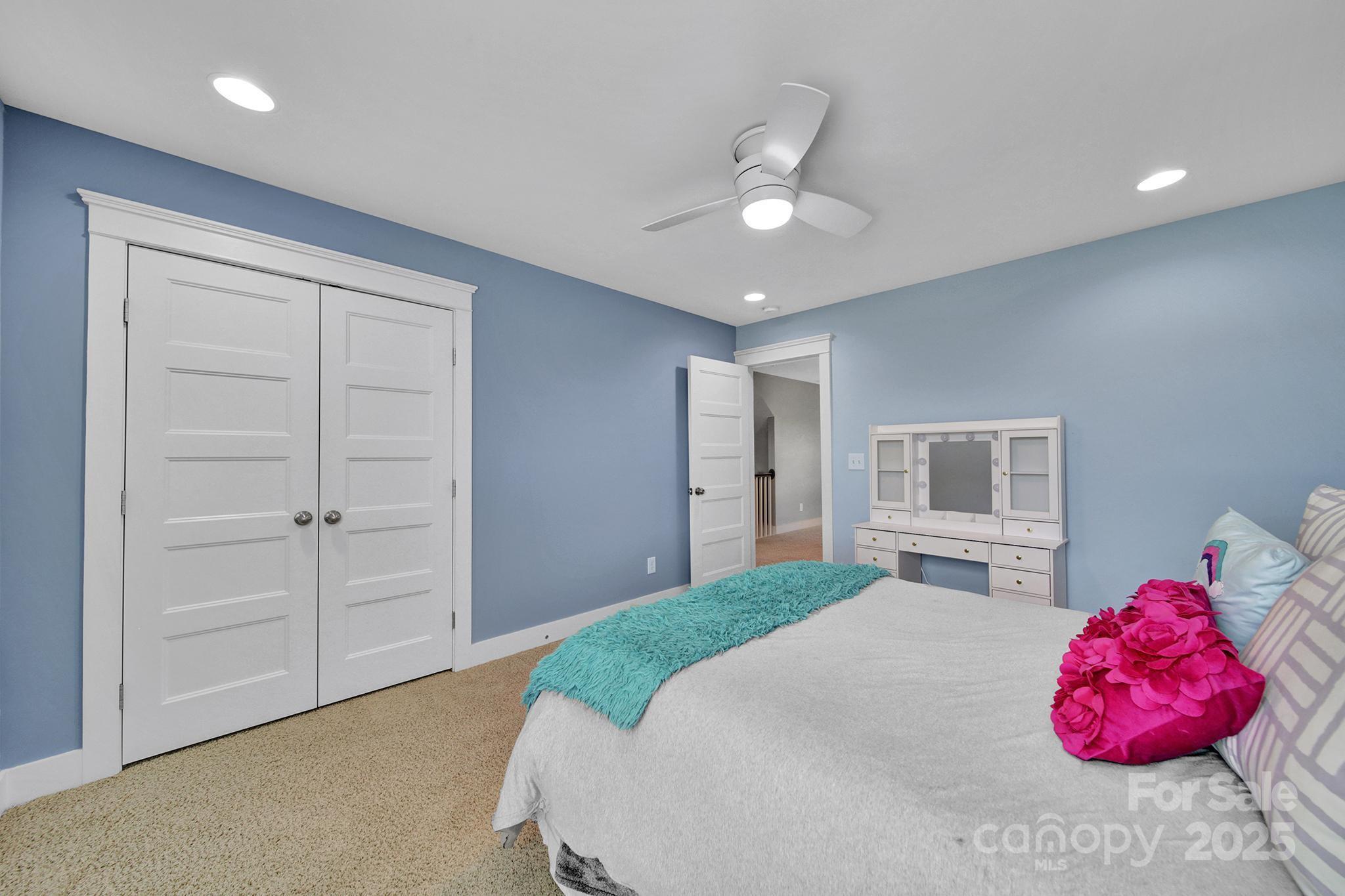 2015 Knocktree Drive Indian Trail, NC 28079 - Photo 27 of 45 a bedroom with a bed and a chandelier