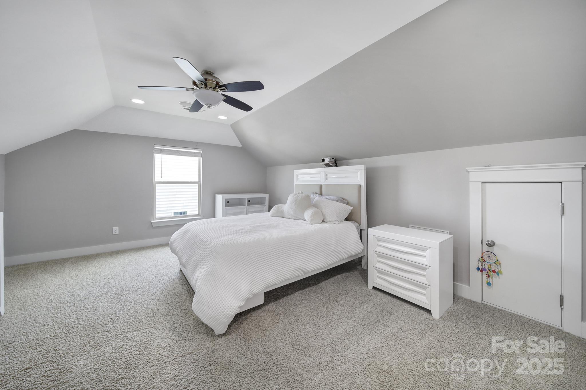 2015 Knocktree Drive Indian Trail, NC 28079 - Photo 33 of 45 a spacious bedroom with a bed and a chandelier