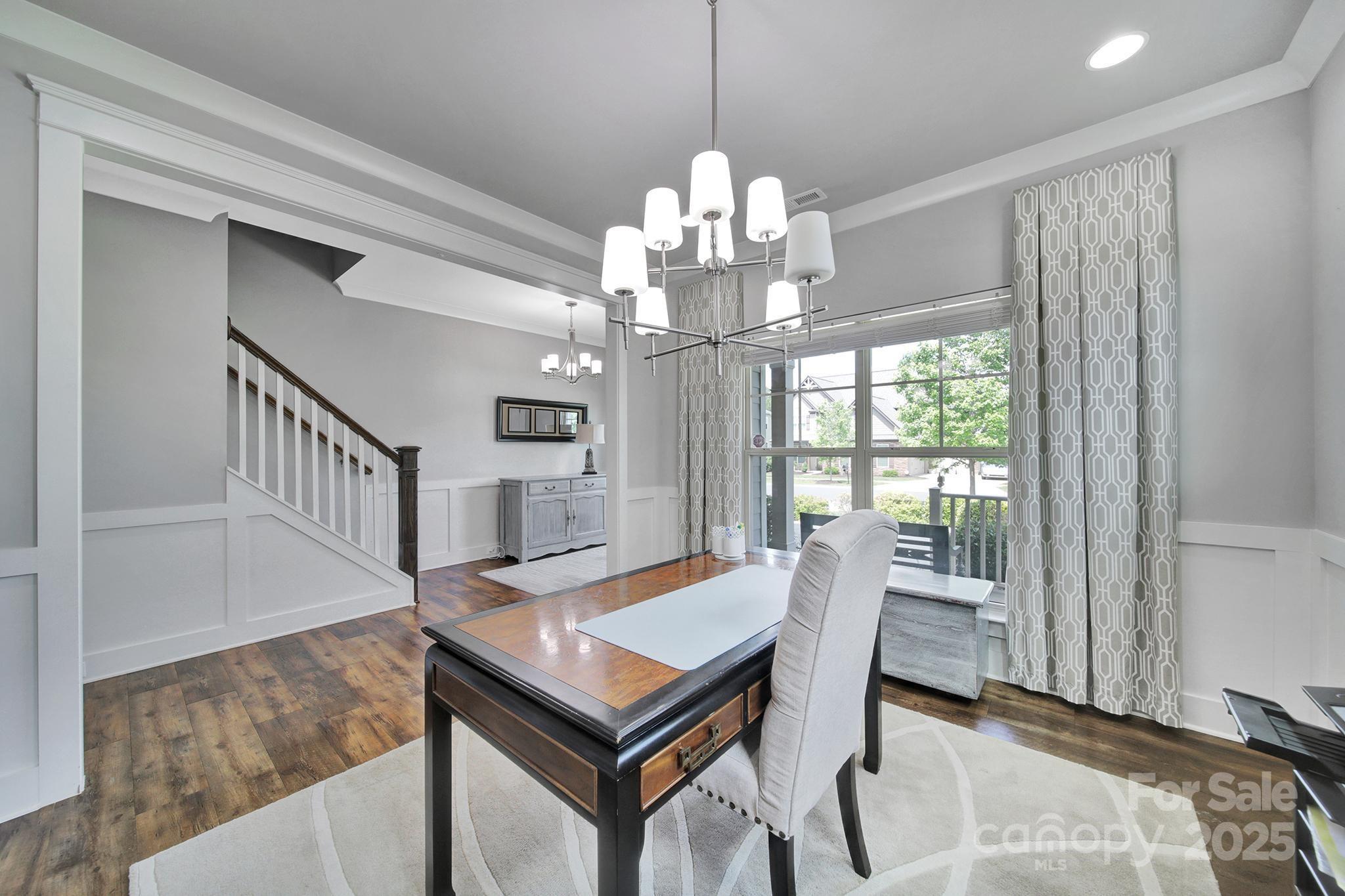 2015 Knocktree Drive Indian Trail, NC 28079 - Photo 4 of 45 a view of a dining room with furniture a chandelier and wooden floor