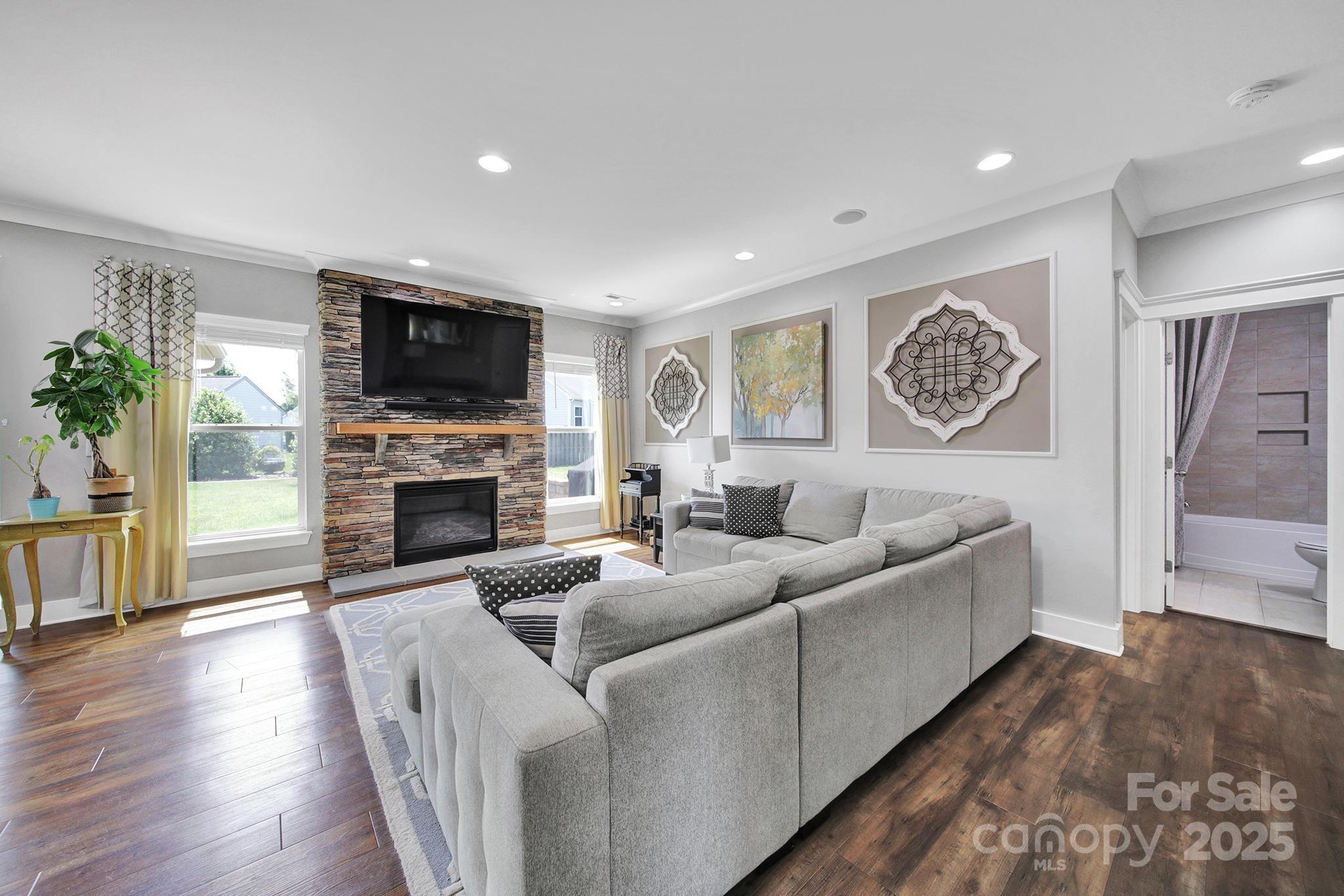 2015 Knocktree Drive Indian Trail, NC 28079 - Photo 5 of 45 a living room with furniture a flat screen tv and a fireplace