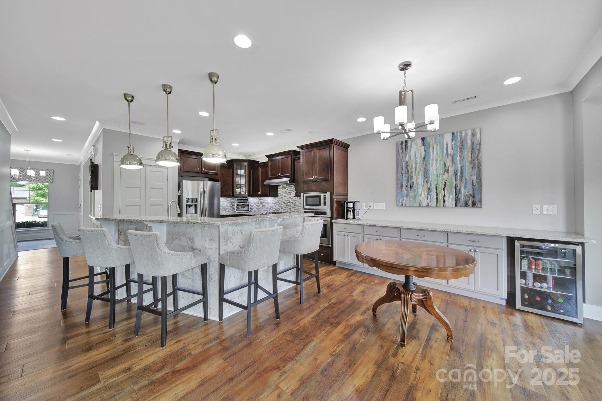 2015 Knocktree Drive Indian Trail, NC 28079 - Photo 8 of 45 a room with stainless steel appliances kitchen island granite countertop furniture and a dining table with wooden floor
