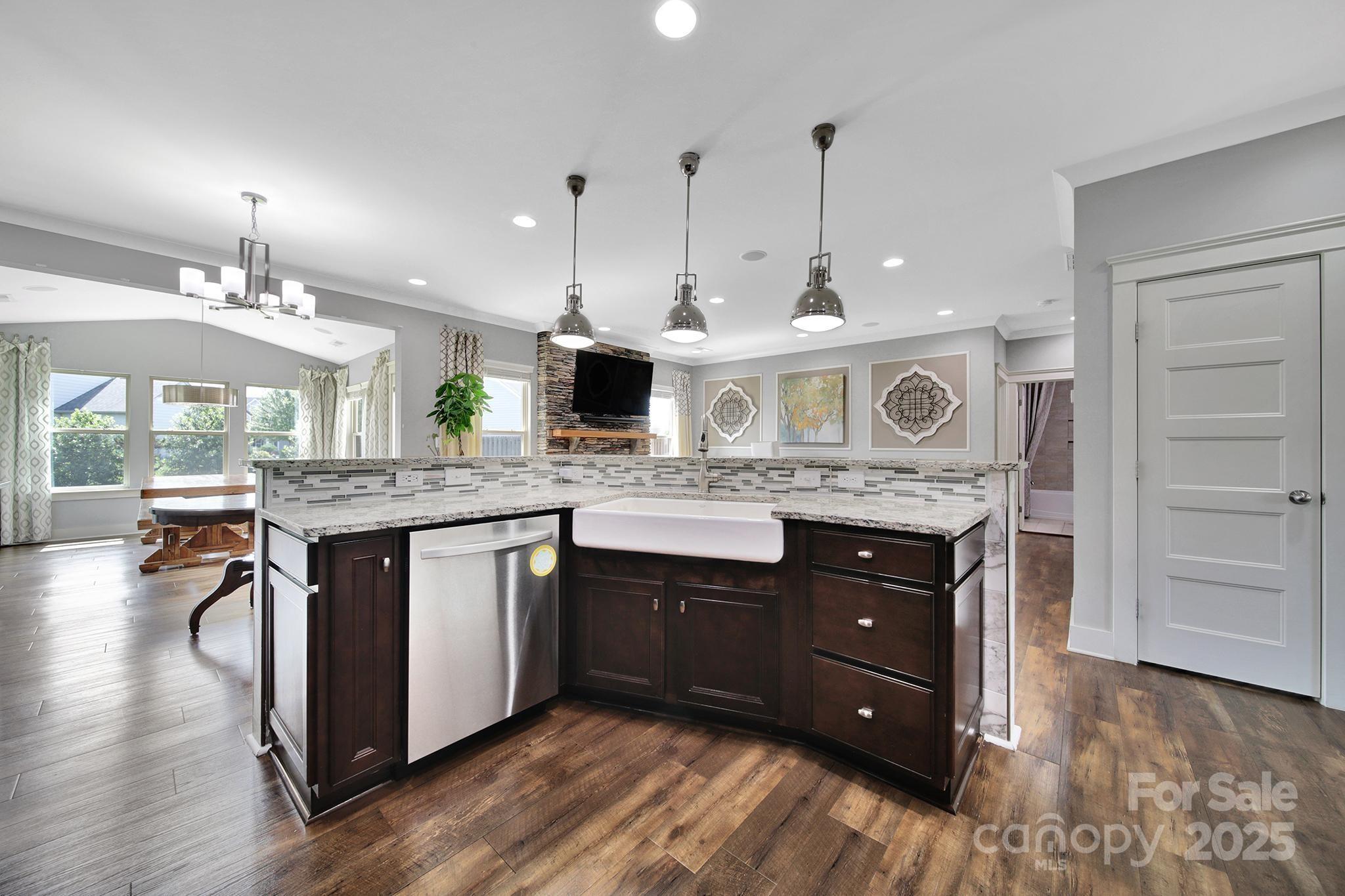 2015 Knocktree Drive Indian Trail, NC 28079 - Photo 9 of 45 a kitchen with stainless steel appliances granite countertop a stove a sink and a wooden floors