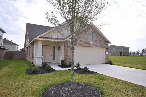 a view of a house with a yard and pathway
