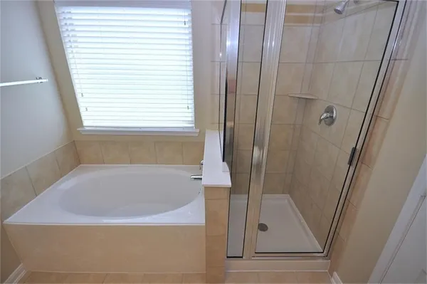 a bathroom with a bathtub and a shower