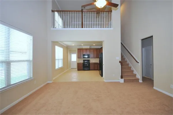 a view of hallway with livingroom and stairs