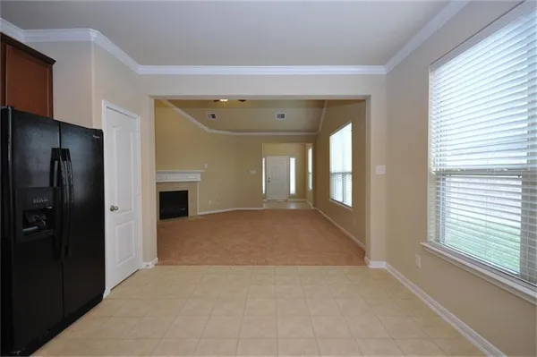 a view of hallway with livingroom and a window