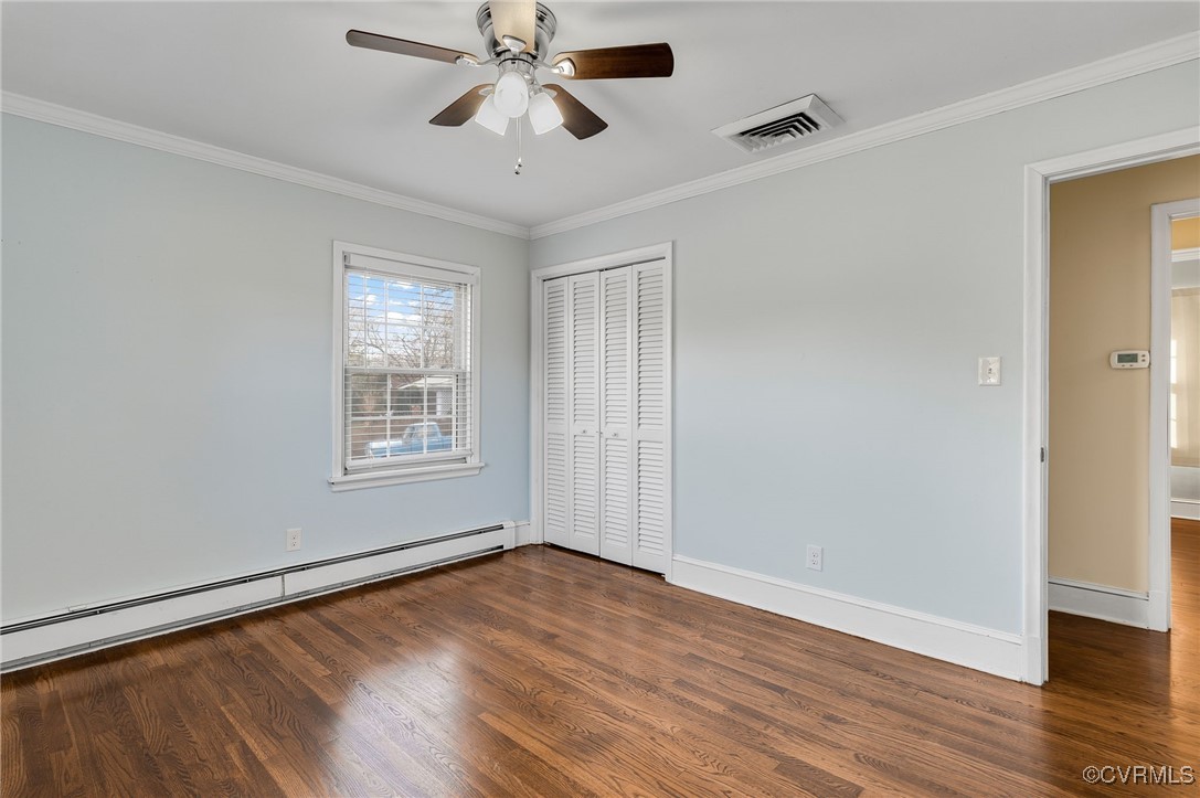 12047 Sunset Drive Ashland, VA 23005 - Photo 14 of 26 an empty room with wooden floor chandelier fan and windows