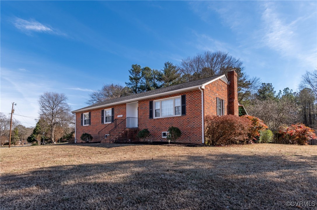 12047 Sunset Drive Ashland, VA 23005 - Photo 2 of 26 a front view of a house with a yard and outdoor seating
