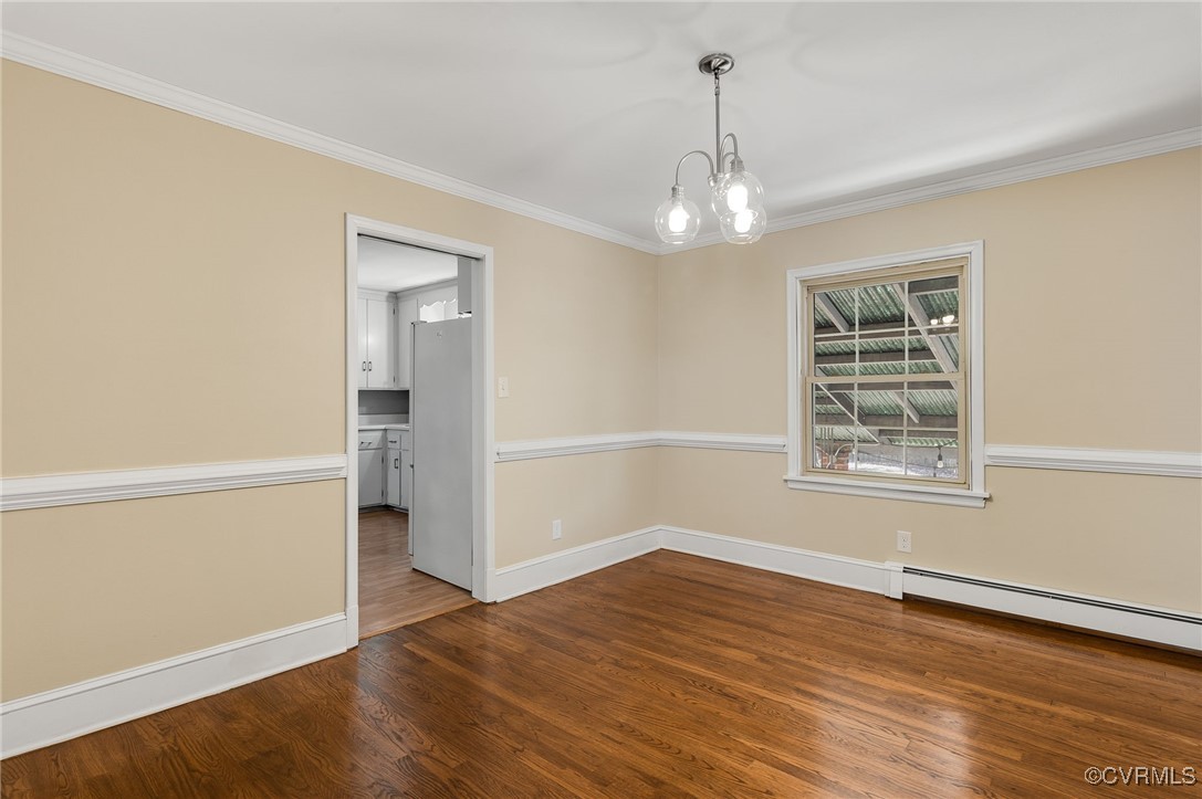 12047 Sunset Drive Ashland, VA 23005 - Photo 7 of 26 an empty room with wooden floor chandelier and windows