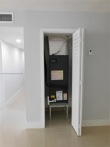 a living room with a furniture and a potted plant
