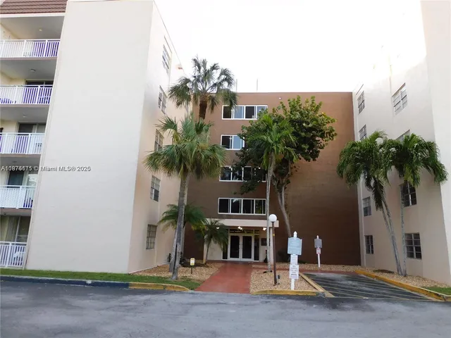 a front view of multiple houses with yard