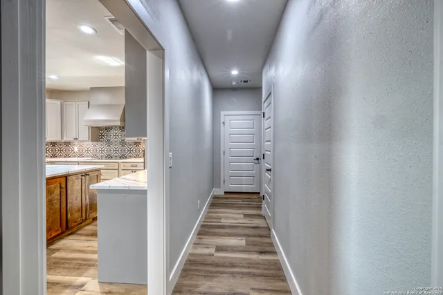 a kitchen with kitchen island granite countertop a sink cabinets and stainless steel appliances