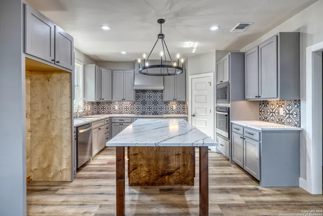 a view of a kitchen with a sink and a stove