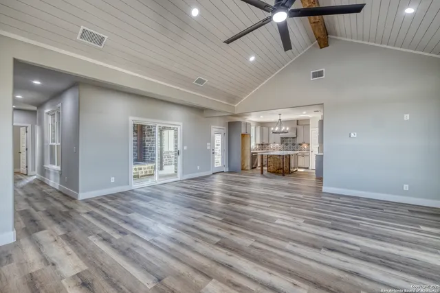 a bathroom with a granite countertop double vanity sink and a mirror