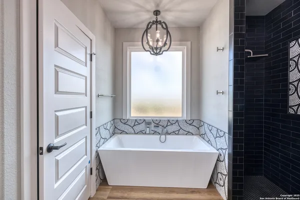 a bathroom with double vanity sinks and a mirror