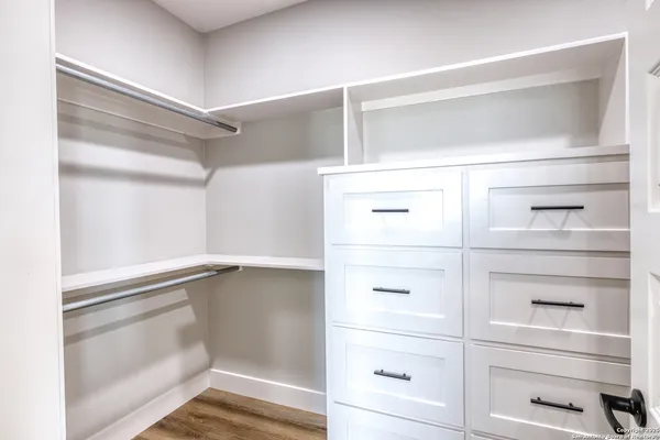 a bathroom with a granite countertop sink a toilet and bathtub