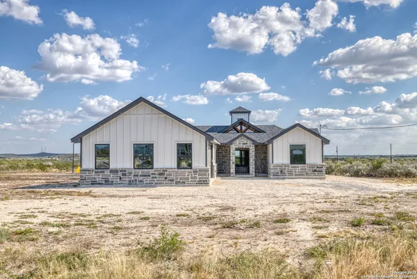a view of a house with a yard covered in snow