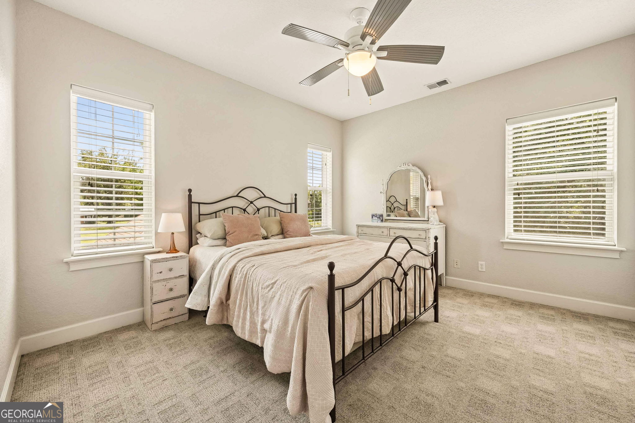 706 Hopewell Point Road White Oak, GA 31568 - Photo 40 of 84 This spacious guest bedroom offers ample natural light, plush carpeting, and a comfortable layout for family or visitors.