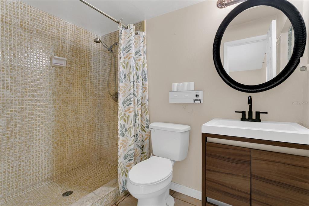 561 East Orange Street Altamonte Springs, FL 32701 - Photo 17 of 24 a bathroom with a sink a toilet and a mirror